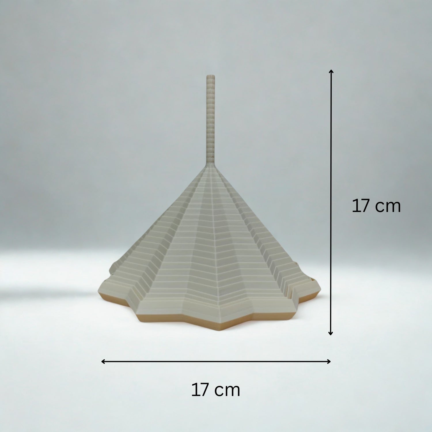 Decorative item with dimensions indicated on a gray background